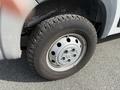 Close-up of a wheel and tire on a 2017 RAM Promaster with a silver rim and a textured black tire tread