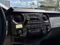 Interior dashboard of a 2014 Ford F-250 SD featuring radio controls and air conditioning knobs