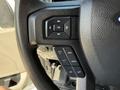 A steering wheel with control buttons for navigation and settings in a 2019 Ford F-550