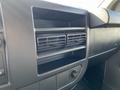 Close-up of the dashboard of a 2014 Chevrolet Express showing air conditioning vents and control knobs