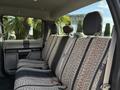 A 2018 Ford F-150 interior featuring front and back seats with patterned fabric upholstery and headrests