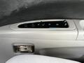 Interior panel of a 2003 Mitsubishi 7 Passenger Van featuring controls for climate and air conditioning on the door armrest