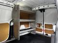 Interior of a 2014 Ford Transit Connect showing a metal shelving unit installed in the cargo area