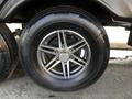A close-up of a tire and alloy wheel from a 2022 Heartland Torque featuring five spokes and a shiny finish