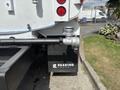 A 2016 Ford F-750 truck showcasing the rear view with visible exhaust system and branding on the side panel