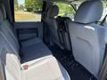 Interior view of a 2014 Ford F-250 SD showing the rear seats with gray fabric upholstery and a clean layout