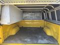The interior of a 2015 RAM 1500 truck bed shows a yellow painted surface with a textured rubber mat and aluminum storage box on one side