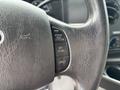Close-up of the steering wheel of a 2014 Ford E-350 featuring cruise control buttons labeled RES SET ACCEL and COAST