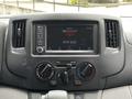 Dashboard of a 2020 Nissan NV200 featuring a touchscreen display with radio information and climate control knobs