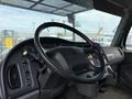 The interior of a 2020 Freightliner M2 featuring a large steering wheel various controls and a dashboard with gauges and indicators