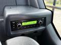 Controls of a 2022 Hyundai R55-9A with a radio display showing FM frequency 87.5 Hz and various buttons for tuning and volume settings