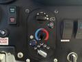 A control panel featuring buttons for engine start and stop along with knobs for temperature and airflow adjustments colored in blue and red