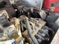 A close-up view of the engine compartment of a 2014 Toro Groundmaster 5910 featuring various hoses and electrical components