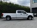 A white 2017 Ford F-250 truck is shown from the side with a single cab and long bed design