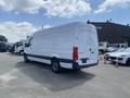 A white 2025 Mercedes-Benz Sprinter van is parked, showcasing its rear and side profile with a sleek design and no visible markings or graphics