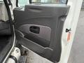 The interior door panel of a 2014 International TerraStar featuring a textured surface and a handle with a horizontal opening for access to the cab.