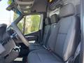 Interior view of a 2019 Mercedes-Benz Sprinter showing the front seats and steering wheel with a focus on the driver's side seat