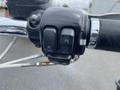 Close-up of a Harley-Davidson motorcycle handlebar control featuring buttons for start off and run functions