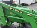 A green 2003 John Deere 790 tractor with a loader attachment prominently featuring the name "JOHN DEERE" in bold yellow letters