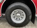 Close-up of a wheel from a 2009 Spartan Gladiator featuring a shiny silver rim with multiple bolts and a thick black tire marked with the brand name Michelin and size details
