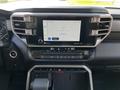 The interior dashboard of a 2023 Toyota Tundra featuring a digital touchscreen display with audio controls and climate settings