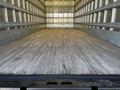 A 2016 Freightliner M2 106 truck with an empty wooden cargo area showing clear floor space and metal walls