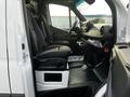 Interior of a 2022 Mercedes-Benz Sprinter showing the driver's and passenger's seats with a modern dashboard and controls