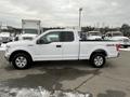 A white 2017 Ford F-150 pickup truck with a crew cab and 4x4 drive shown from the side