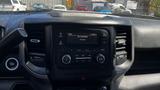 Dashboard display of a 2019 RAM 3500 showing radio controls and a digital clock