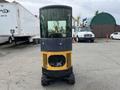 A 2024 AGT Industrial Yellow H13R Mini Excavator viewed from the front with a glass cabin and large front wheels
