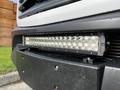 A close-up of a LED light bar mounted on the front bumper of a 2017 Mercedes-Benz Sprinter