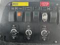Control panel of a 2009 Spartan Gladiator featuring various switches dials for siren horn chains green start and two 12 volt outlets
