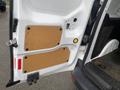 A white 2017 Ford Transit Connect van door with two cork panels installed on the interior surface