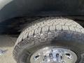 Close-up of a tire and wheel from a 2022 GMC Savana showcasing detailed tread pattern and shiny chrome rim