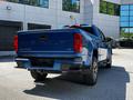 A blue 2021 Chevrolet Colorado pickup truck viewed from the rear with a visible Chevrolet logo and Colorado lettering on the tailgate