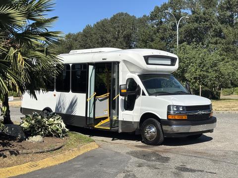 2017 Chevrolet Express with a white exterior and large front windshield features open side doors and a sleek design typically used for passenger transport