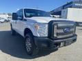 A 2014 Ford F-250 SD facing front with a shiny chrome grille and alloy wheels