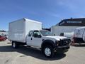 A white 2008 Ford F-450 SD with a box truck body and dual rear wheels parked at an industrial lot