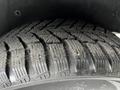 A close-up of a tire tread from a 2016 Ford Transit Connect showing deep grooves and patterns designed for traction on various surfaces