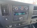 Dashboard of a 2022 GMC Savana showing radio controls and climate settings with digital display