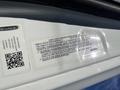 A 2022 Freightliner Cascadia truck interior view featuring the vehicle noise emission control information label