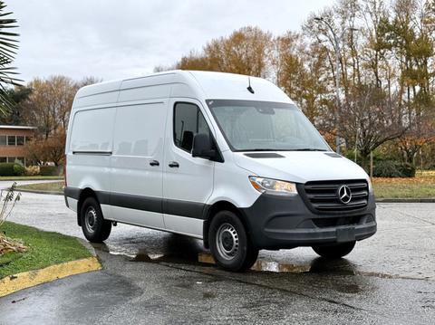 2023 Mercedes-Benz Sprinter van in white with a distinctive grille and large cargo space on the back