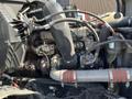 Close-up view of the engine compartment of a 2022 Freightliner Cascadia featuring various components like hoses and pipes