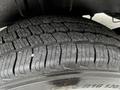 Close-up of a tire tread from a 2019 Mercedes-Benz Sprinter displaying deep grooves and water droplets on its surface