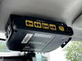 A control panel mounted above in a vehicle with buttons labeled CTRL-F1, AUX, and directional arrows for navigation