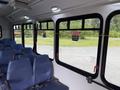 Interior view of a 2020 Chevrolet Express showing blue seats and large windows