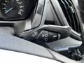 A close-up view of the control stalk in a 2015 Ford Transit featuring symbols for windshield wipers and headlights