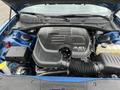 The engine compartment of a 2022 Dodge Charger featuring a 3.6L VVT engine with visible components such as the air intake and various fluid reservoirs