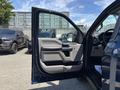 A 2015 Ford F-150 with the driver's door open showcasing the interior features and design of the cabin