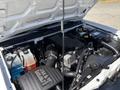A 2011 Chevrolet Colorado engine interior with various components including the air intake system battery and coolant reservoir